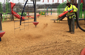 A child plays on playground with Fibertop surfacing