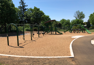 A sunny playground where Fibertop Fiber Weave has been installed
