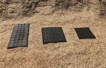 A Fibertop wear mat placed at the bottom of a playground slide